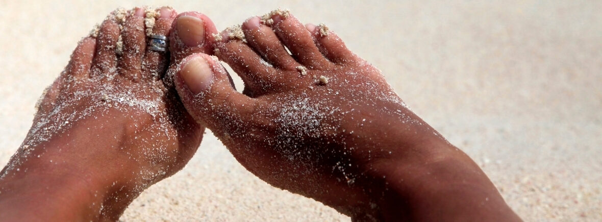 brown feet playing in the sand