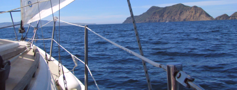 view of ocean and rocky island from a sailboat